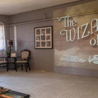 A cozy room set up for a movie screening of 'The Wizard of Oz', featuring comfortable chairs and wall decorations.