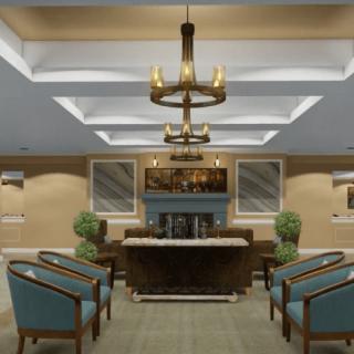 A modern lobby with stylish seating and a central chandelier.