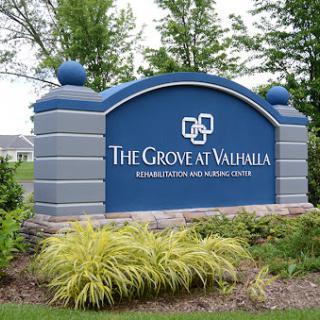 Welcome sign for The Grove at Valhalla, a residential and healthcare center.