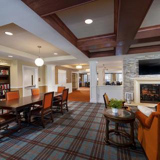 A cozy interior space with a lounge area, conference table, and fireplace.