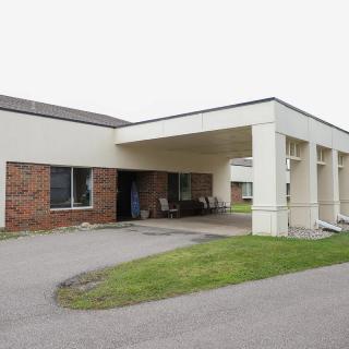 Modern building entrance with brick and white exterior.