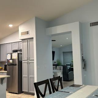 A cozy open-concept kitchen and living room showcasing modern design elements.