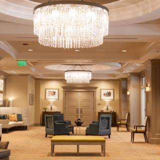 A luxurious hotel lobby with elegant chandeliers and comfortable seating.