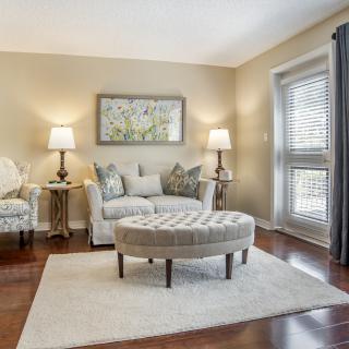 A cozy living room with a sofa, armchair, coffee table, and decorative accents.