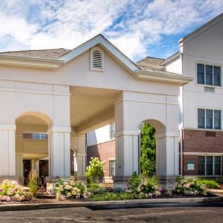 A modern hotel building with a welcoming entrance and well-maintained landscaping.