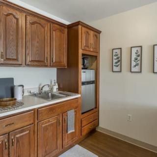 A cozy kitchen space with wooden cabinets and modern appliances.