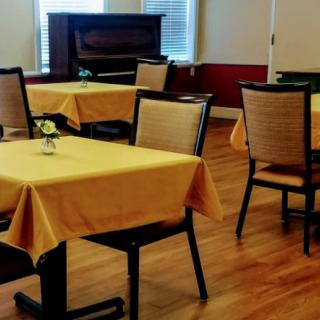 A cozy dining area with tables and chairs neatly arranged.