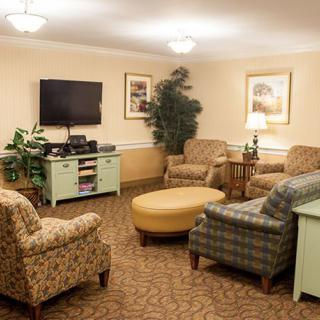 A cozy living room with comfortable seating, a TV, and stylish decor.