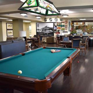 A well-decorated game room featuring a pool table and comfortable seating.