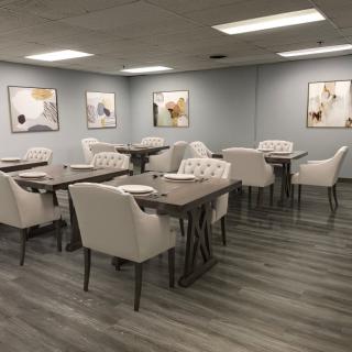 A modern dining area with stylish furniture and elegant artwork on the walls.
