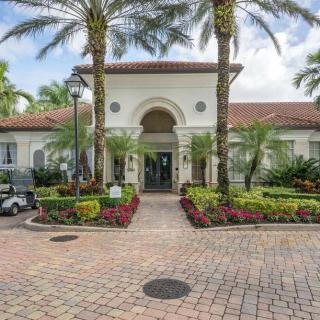A grand entrance with palm trees and vibrant landscaping.