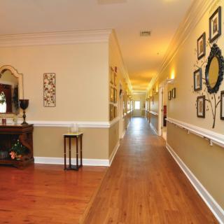 A beautifully decorated hallway with hardwood floors and wall art.