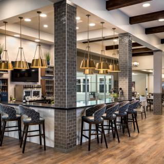 A modern restaurant interior with a stylish bar area and contemporary lighting.