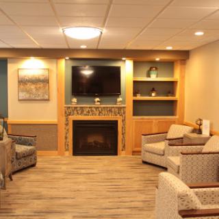 A cozy and inviting living room featuring a fireplace, television, and comfortable seating.