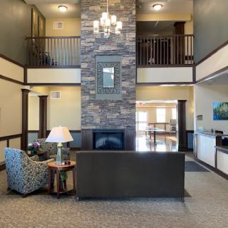 A modern lobby featuring elegant furniture and a stunning stone wall, creating a welcoming atmosphere.