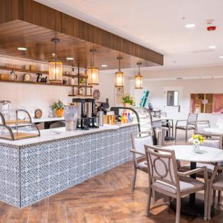 A stylish and modern kitchen space designed for dining, featuring elegant lighting and comfortable seating.