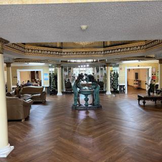 A spacious and elegantly designed lobby featuring comfortable seating and decorative elements.