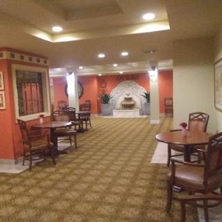 A cozy and inviting lobby space featuring wooden furniture and warm colors.