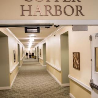A well-lit hallway with the sign 'Copper Harbor' overhead.