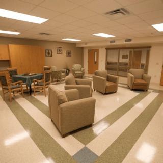 A modern waiting room with comfortable seating arrangements and a table.