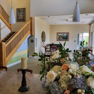A beautifully decorated interior featuring a staircase and a floral arrangement.
