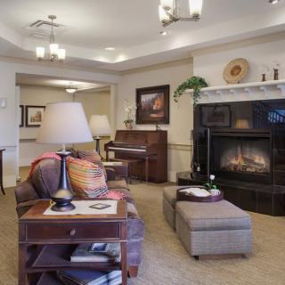 A cozy living room with elegant furniture, a warm fireplace, and stylish decor.