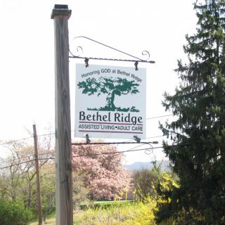 A sign for Bethel Ridge, surrounded by trees and nature.