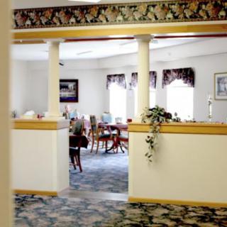 A cozy dining room with elegant furnishings and decorative columns.