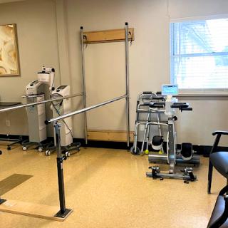 A physical therapy room equipped with rehabilitation tools and exercise equipment.