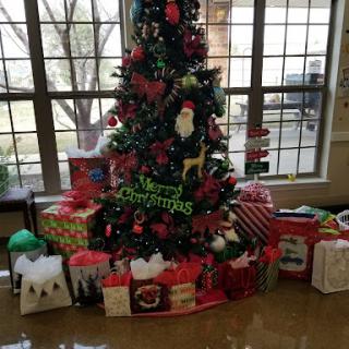 A beautifully decorated Christmas tree surrounded by an assortment of colorful presents.
