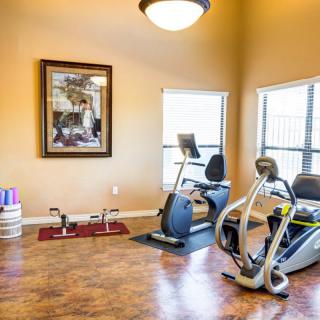 A small fitness room with exercise bikes and workout equipment.