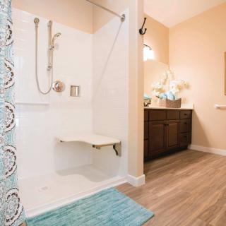 Modern bathroom with a walk-in shower and bench seating.