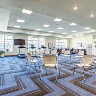 An empty conference room set up for a meeting with chairs arranged in rows.