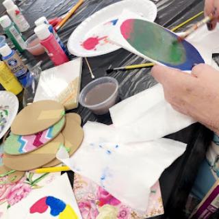 A vibrant art session in progress, filled with colorful paints and creative expressions.