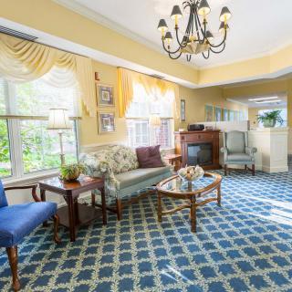 A traditional living room with elegant furnishings and a chandelier.