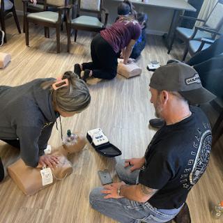 A group of individuals working together on packaging items in a collaborative workspace.