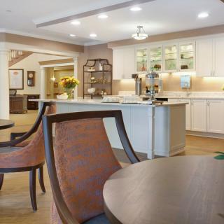 A modern kitchen and dining area with stylish furniture and bright lighting.