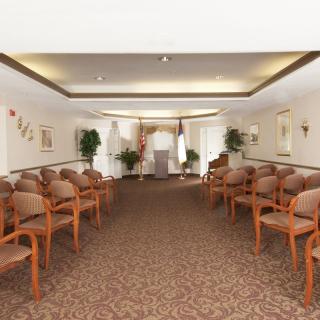 A well-arranged conference room with rows of chairs and neutral decor.