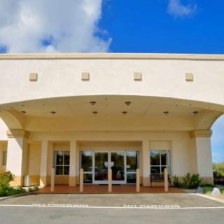 A modern building entrance under a clear blue sky.