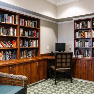 Cozy study room with bookshelves and a computer desk.