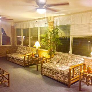 A cozy living room with wicker furniture and warm lighting.