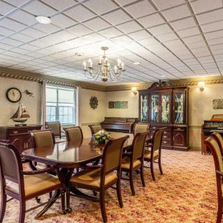 An elegant dining room with traditional furniture and a chandelier.