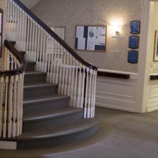 A view of the interior lobby featuring a spiral staircase and decorative railing.