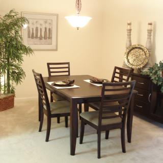 A cozy and elegantly decorated dining room with a wooden table, chairs, and decorative elements.