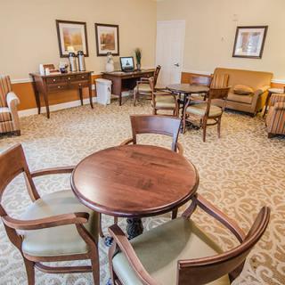 A cozy lounge area with tables and chairs arranged for seating.