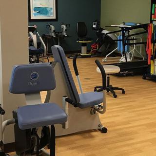 An indoor gym with various exercise machines and equipment.