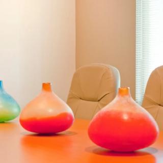 Colorful vases adorn a modern office meeting room.