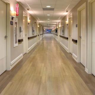 A long, clean hallway in a hospital setting.