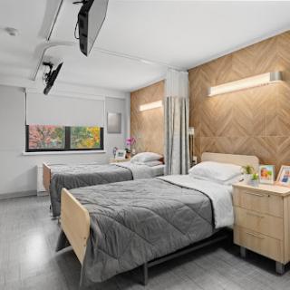 A modern bedroom featuring twin beds, stylish wood paneling, and contemporary decor.