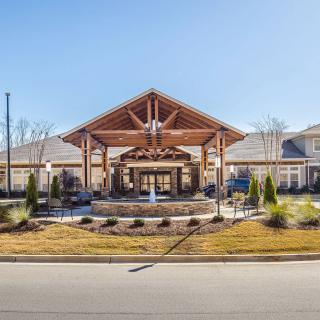 A modern building with a decorative entrance and fountain.